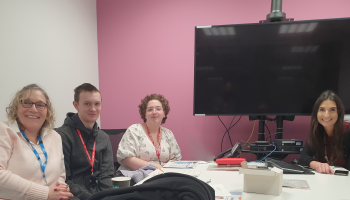 Two young carers and two members of staff from NBT sat around a table