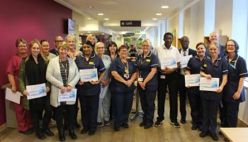 Image of a group of staff members holding certificates 