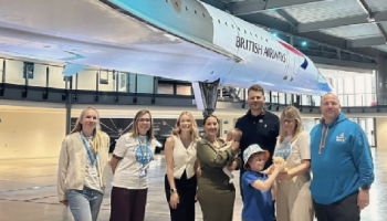 A group of people stood next to Concorde