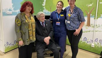 Fiona, Harry, Beth Deverson (senior sister in Elgar Enablement Unit) and Laura Tanner (Music manager at NBT) are pictured standing in front of the new piano smiling.