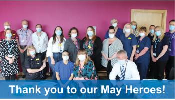 Image of members of staff posed for a photo with blue banner along the bottom which reads "Thank you to our May Heroes!"